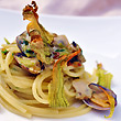 Durum wheat spaghetti with clams and zucchini flowers melted of Provolone del Monaco DOP