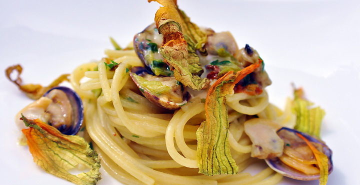 Durum wheat spaghetti with clams and zucchini flowers melted of Provolone del Monaco DOP